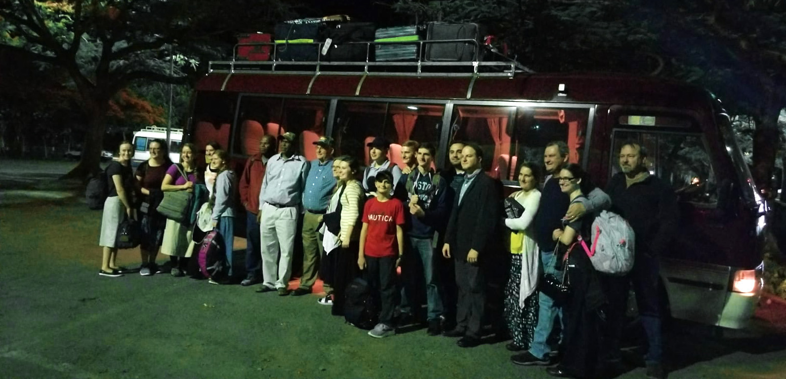 Group photo in front of the bus.