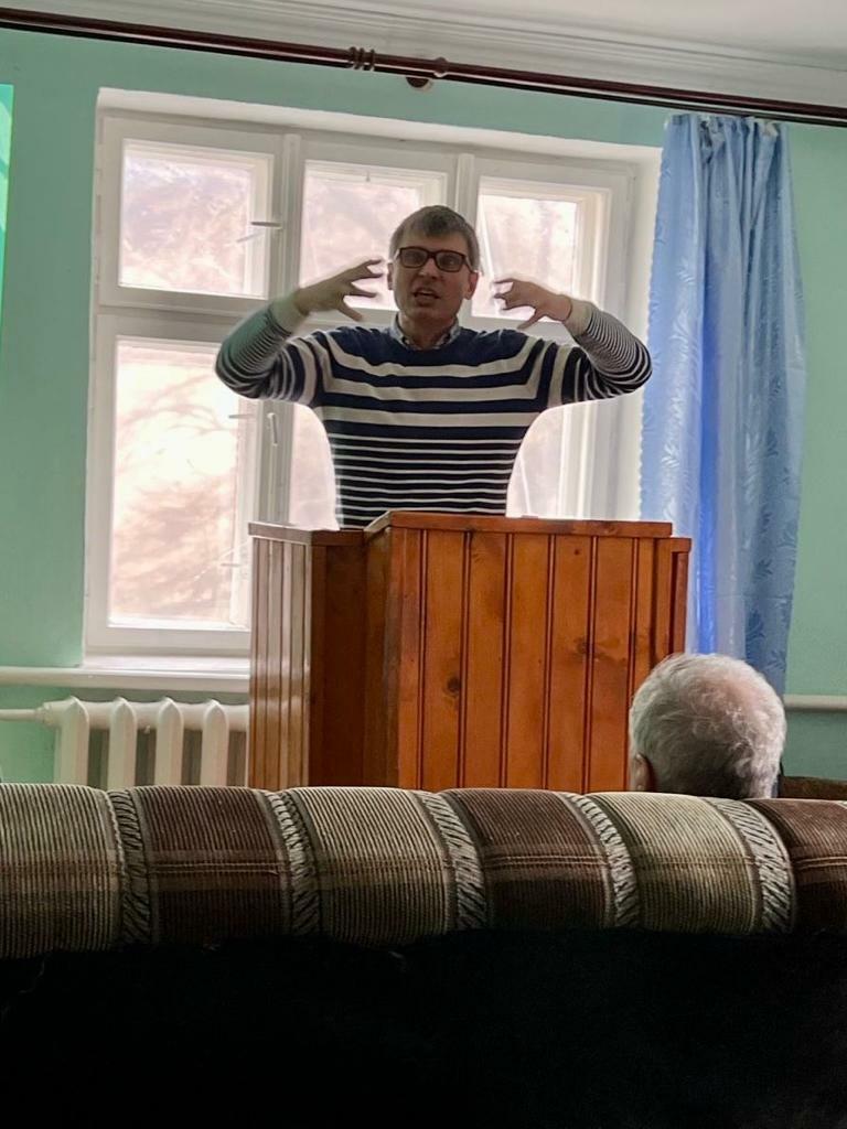 Brother Kostya preaching Sunday service. Brother Kostya is in charge of distributing funds