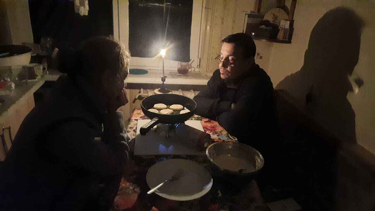 Bro. Ivanov cooking in the dark in the city of Mariupol during bombing raids.